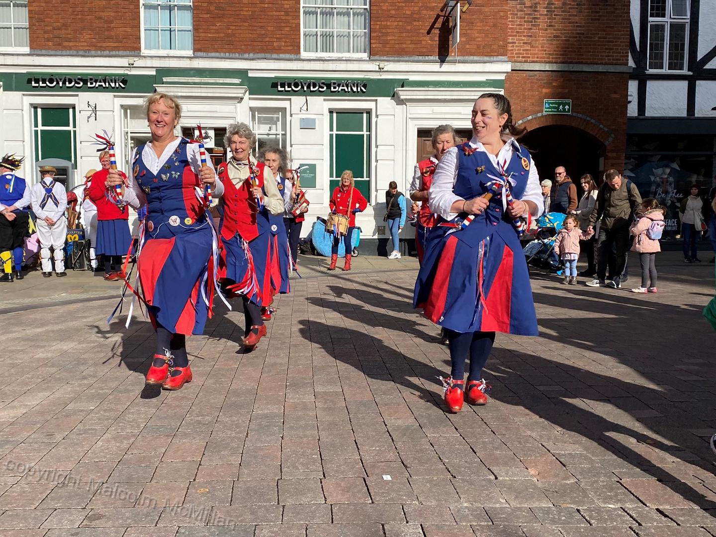 dancers casting long shadows in bright autumn sunshine